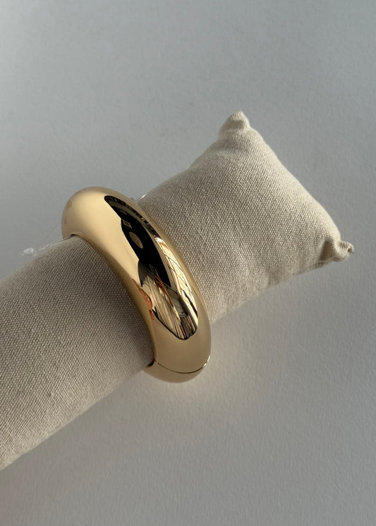 Bracciale rigido dorato bombato
