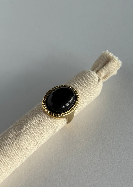 Anello dorato con pietra ovale nera